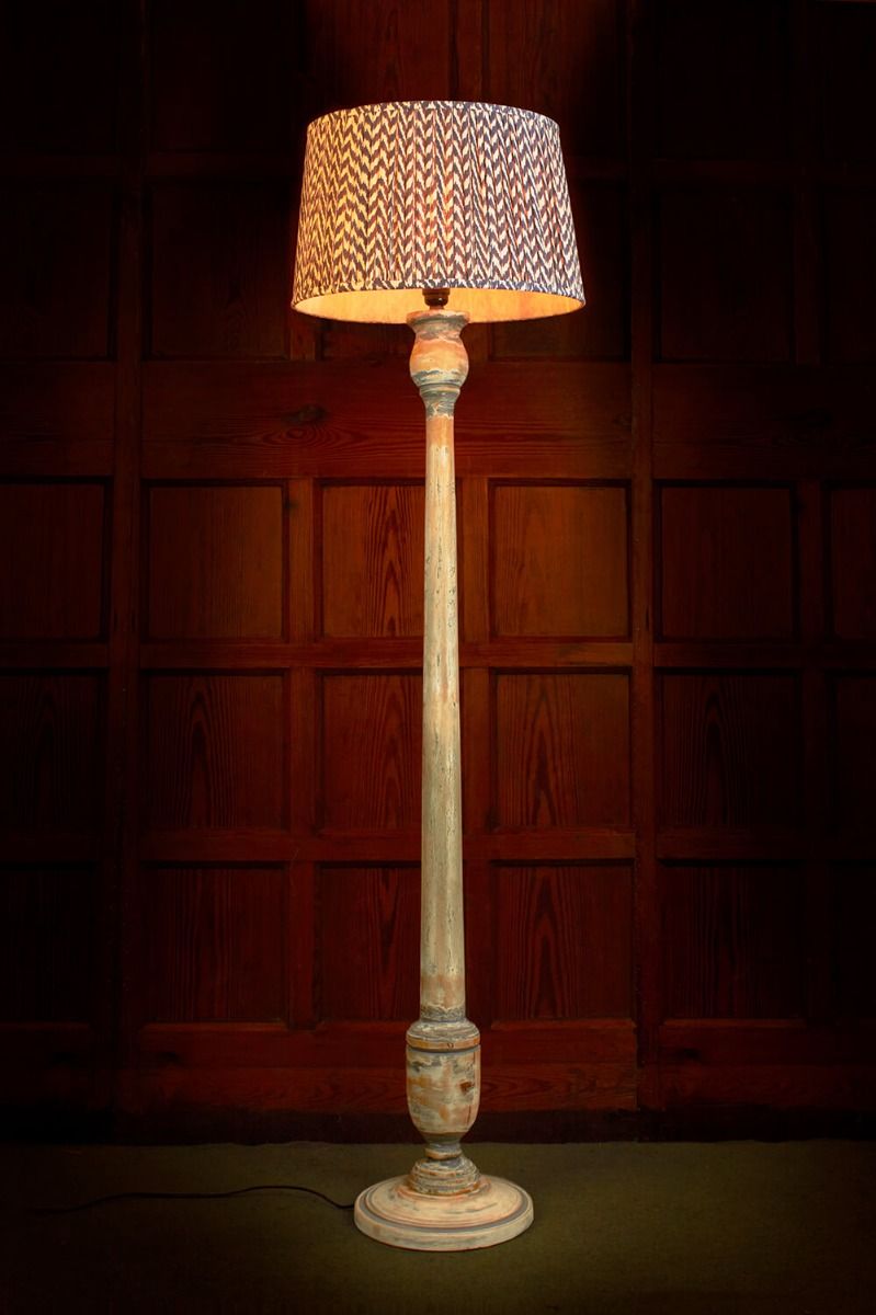 Floor lamp with distressed wooden stand and silk patterned shade