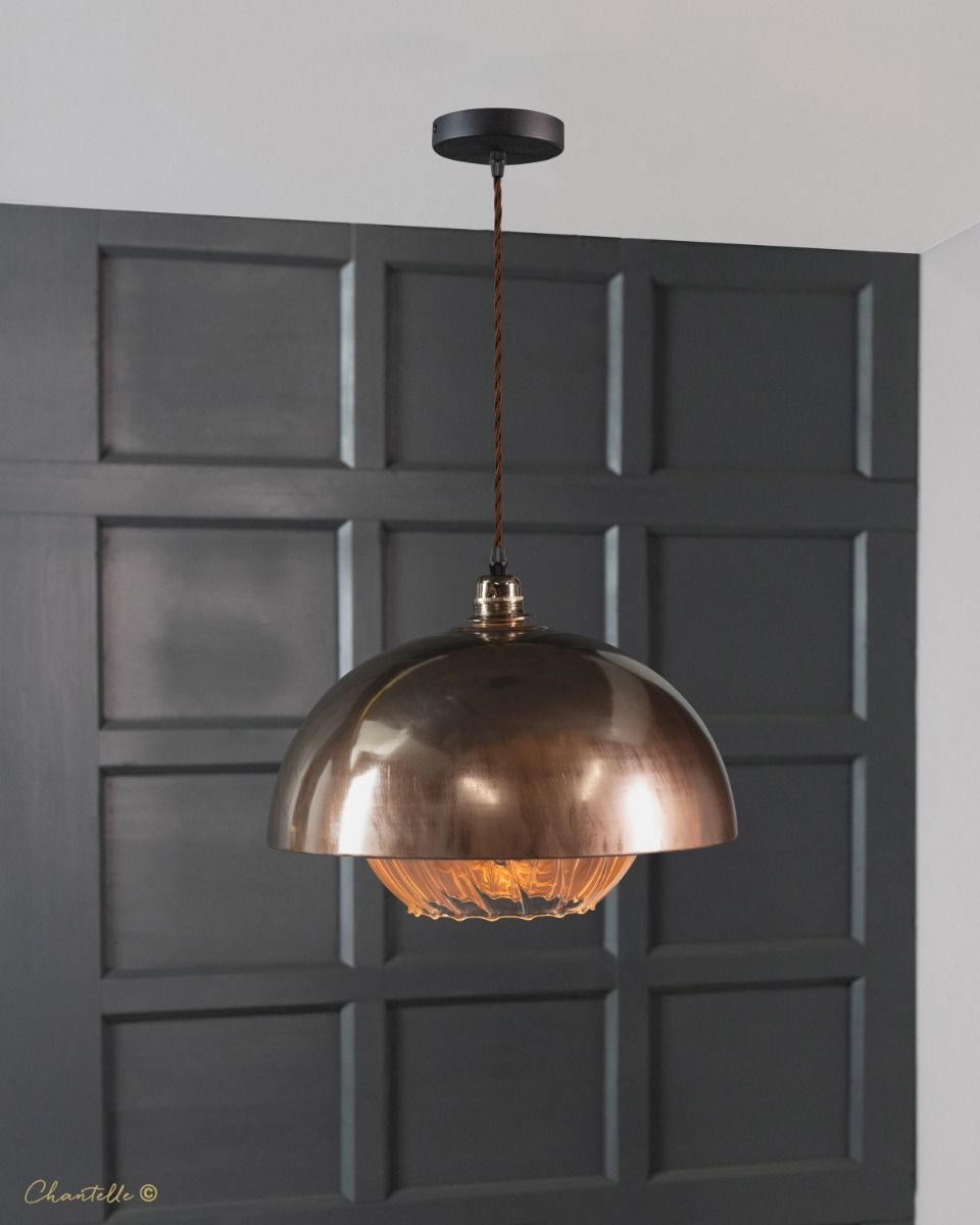polished copper pendant with pumpkin glass