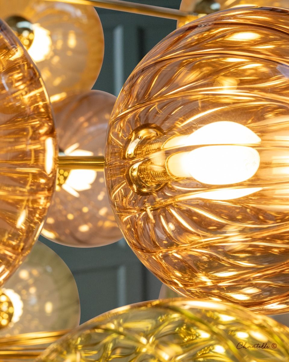 Multi arm brass chandelier with multi coloured pumpkin globes