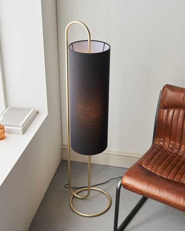 Oval structural antique brass floor light with black fabric shade