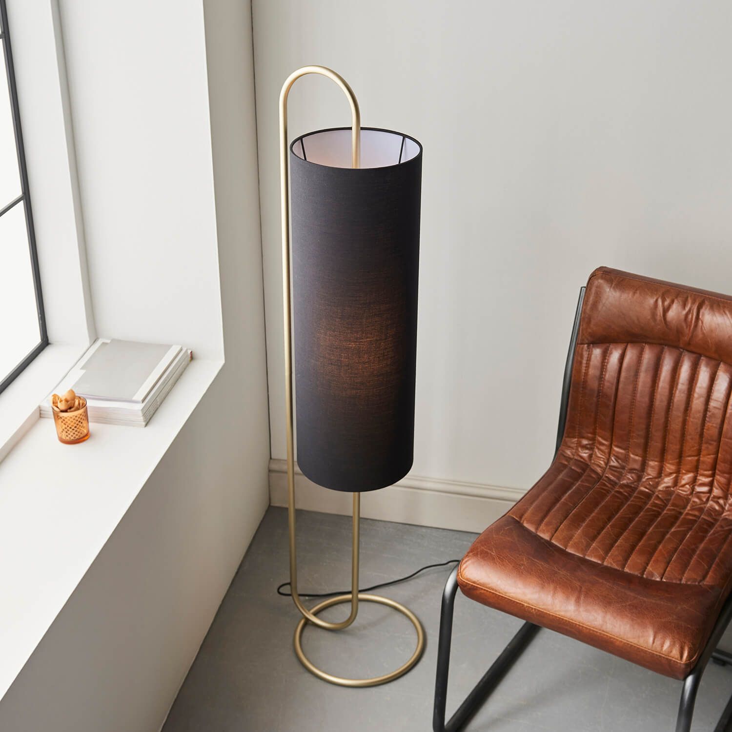 Oval structural antique brass floor light with black fabric shade