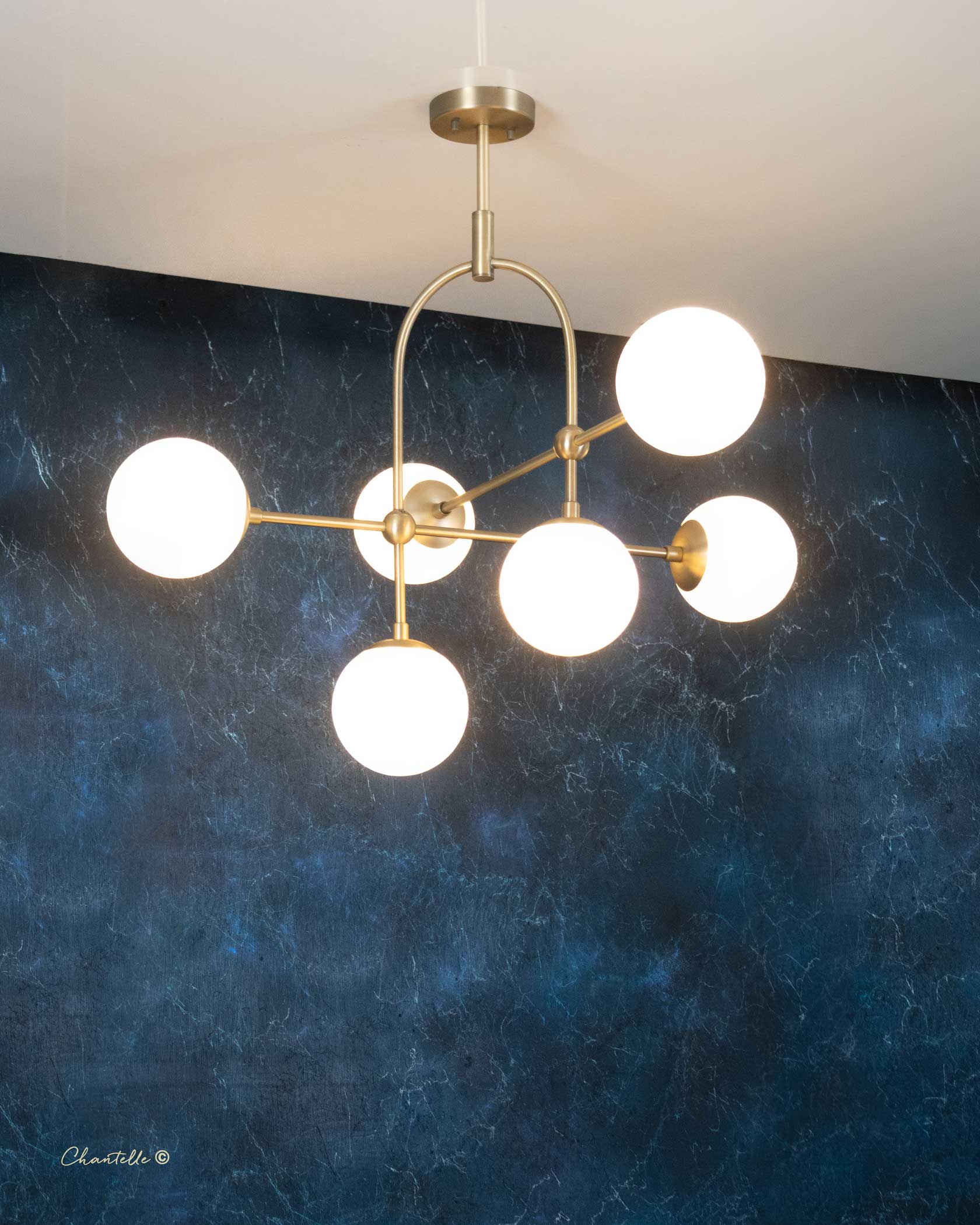 The Chantelle Lighting Brass Arched Opal Globe Chandelier