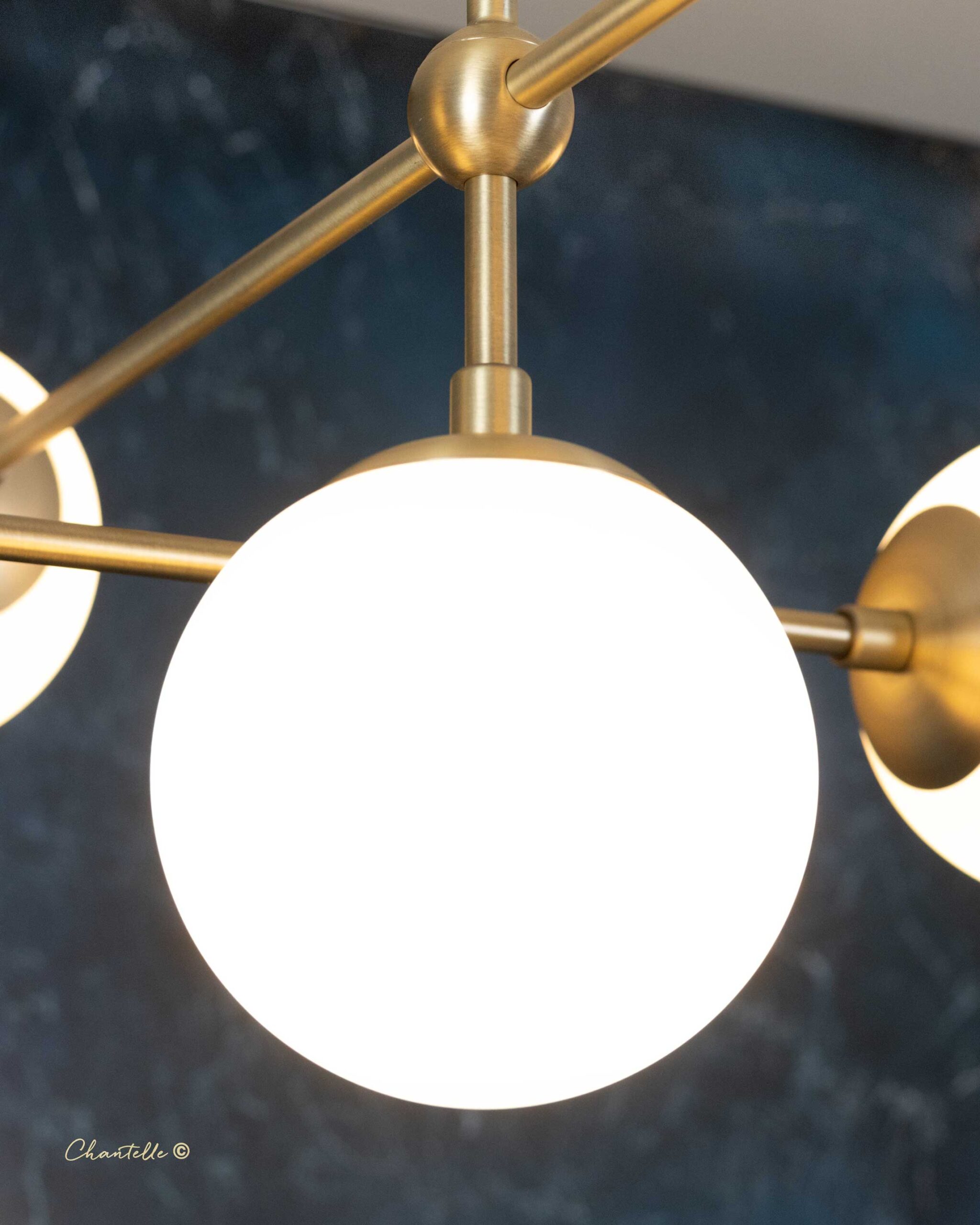 The Chantelle Lighting Brass Arched Opal Globe Chandelier