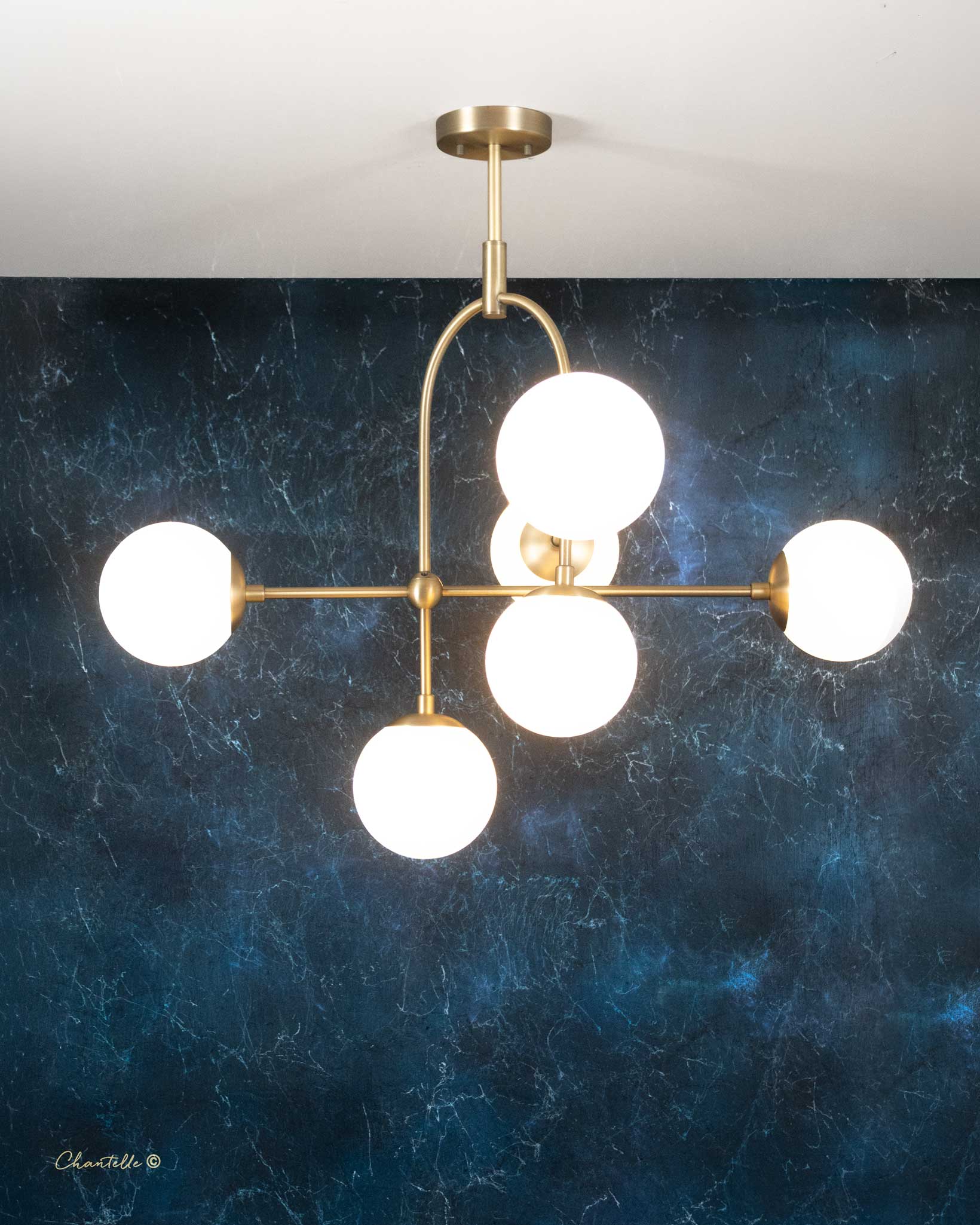 The Chantelle Lighting Brass Arched Opal Globe Chandelier