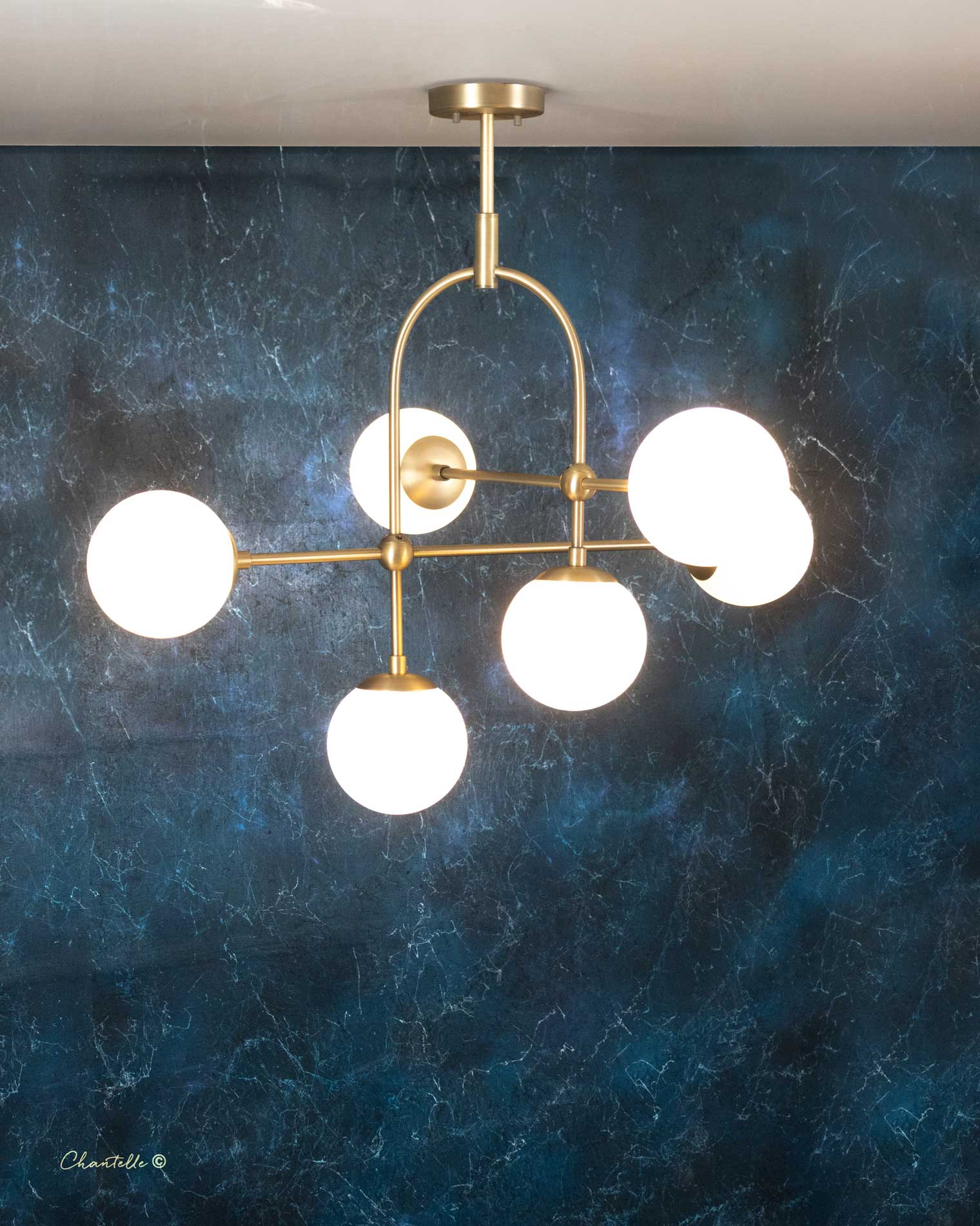 The Chantelle Lighting Brass Arched Opal Globe Chandelier